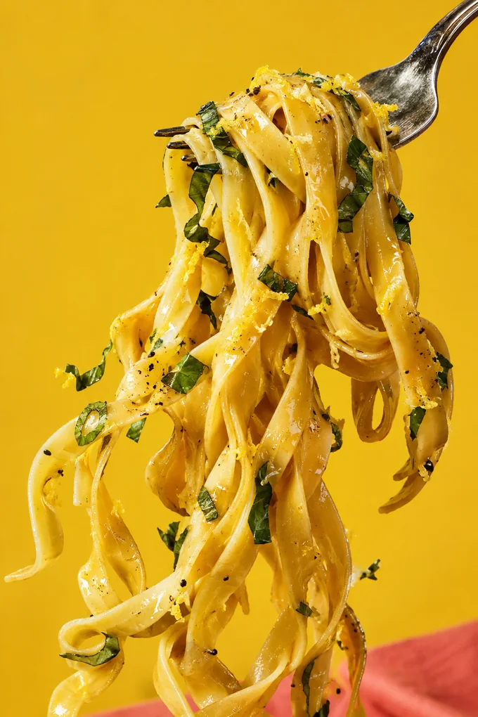 Tagliatelle ribbons lifted on a fork